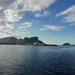 House On Beautiful Vaeroy, Mountains And Sea Outside The Window