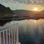 House On Beautiful Vaeroy, Mountains And Sea Outside The Window